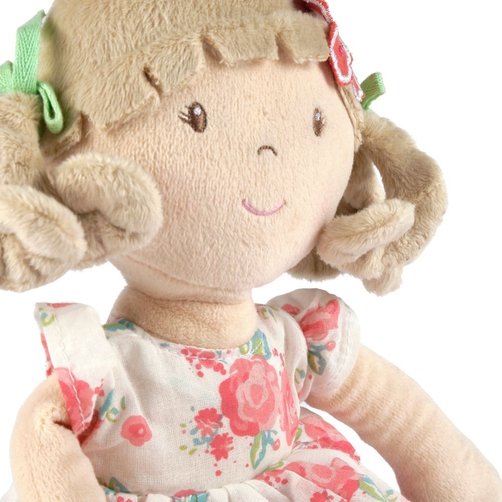 Poupée souple aux cheveux beige en robe rose à fleurs