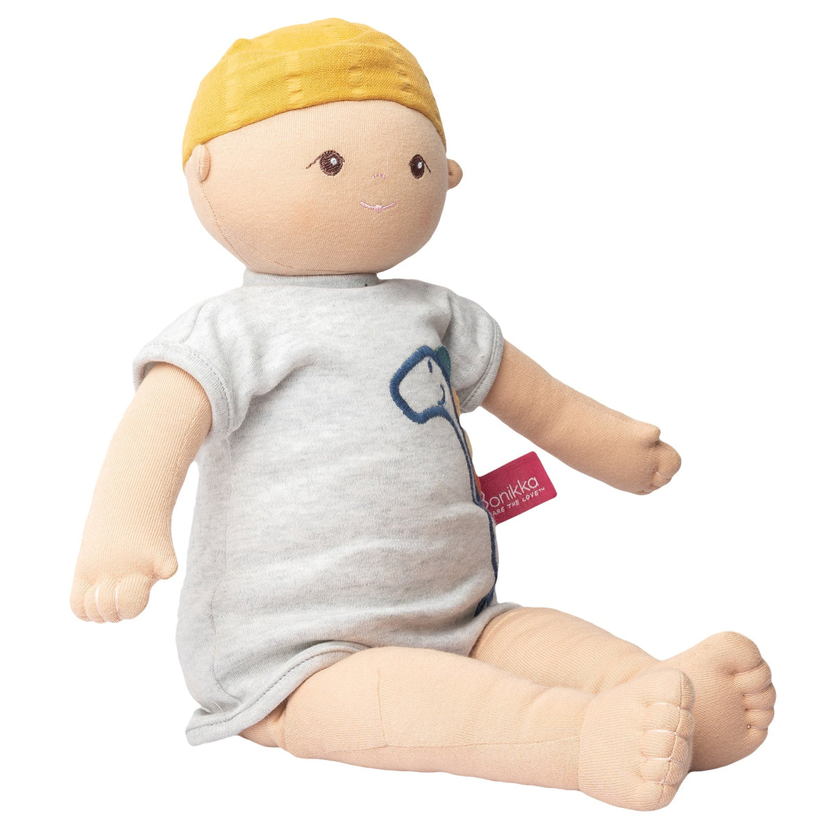 Poupée douce bio en pyjama dinosaure et bonnet jaune